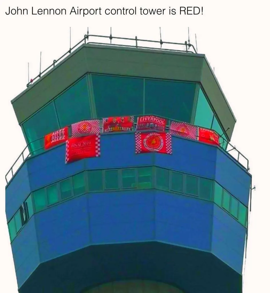 John Lennon airport control tower covered in Liverpool flags