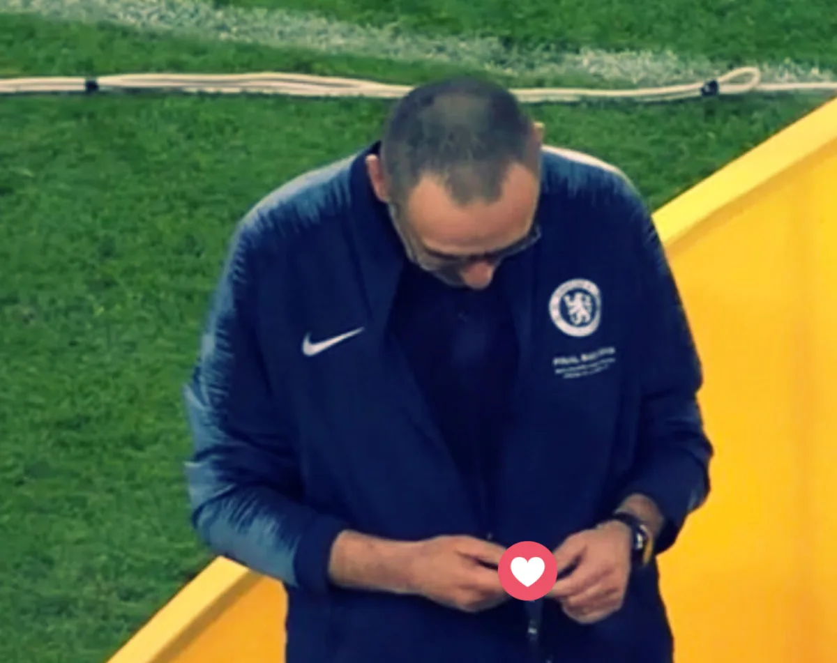 Sarri looking at his gold medal after winning the Europa League with Chelsea