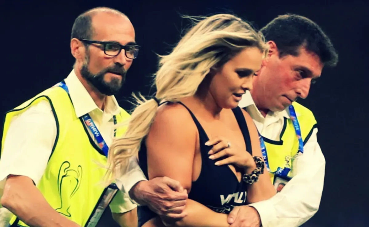 Female streaker escorted by police at the Wanda Metropolitano