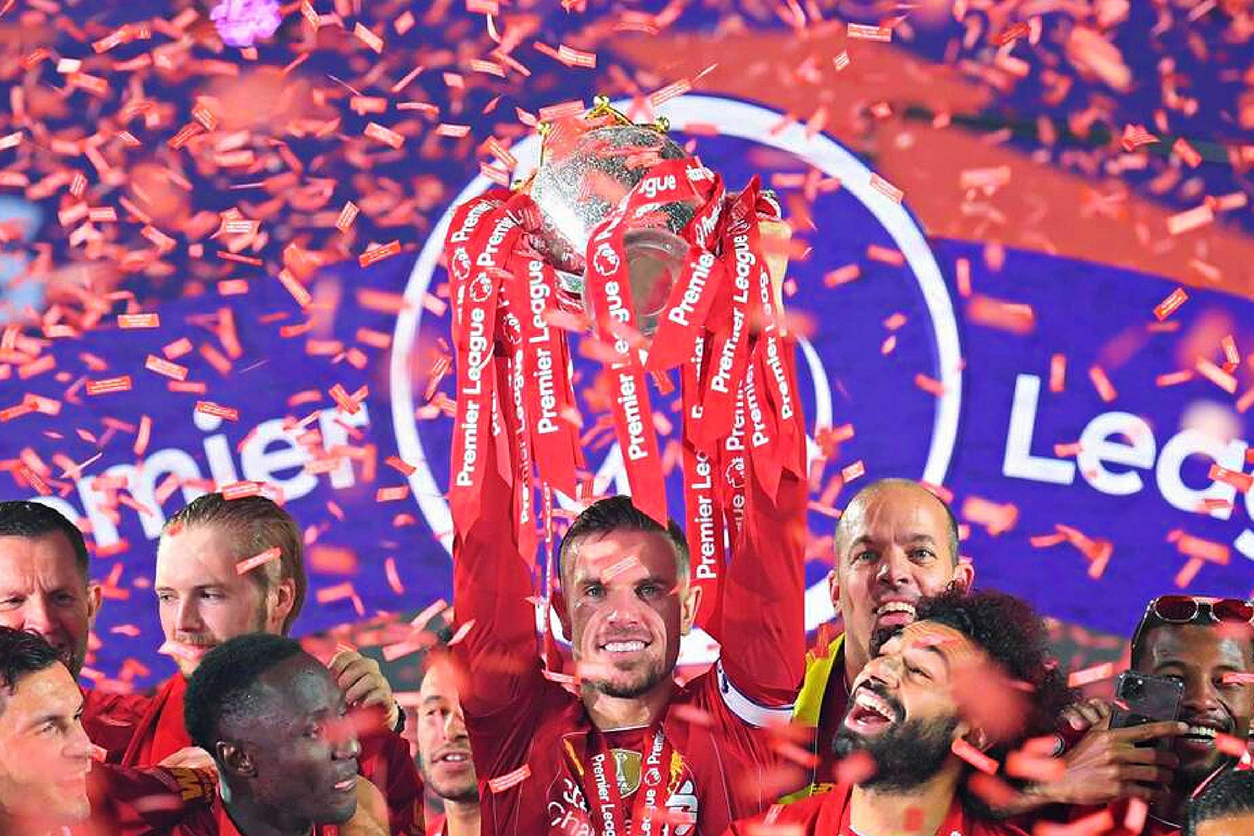 Jordan Henderson and Liverpool players lift the Premier League trophy
