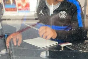 West Ham employee wearing PSG jacket while working in the ticket office