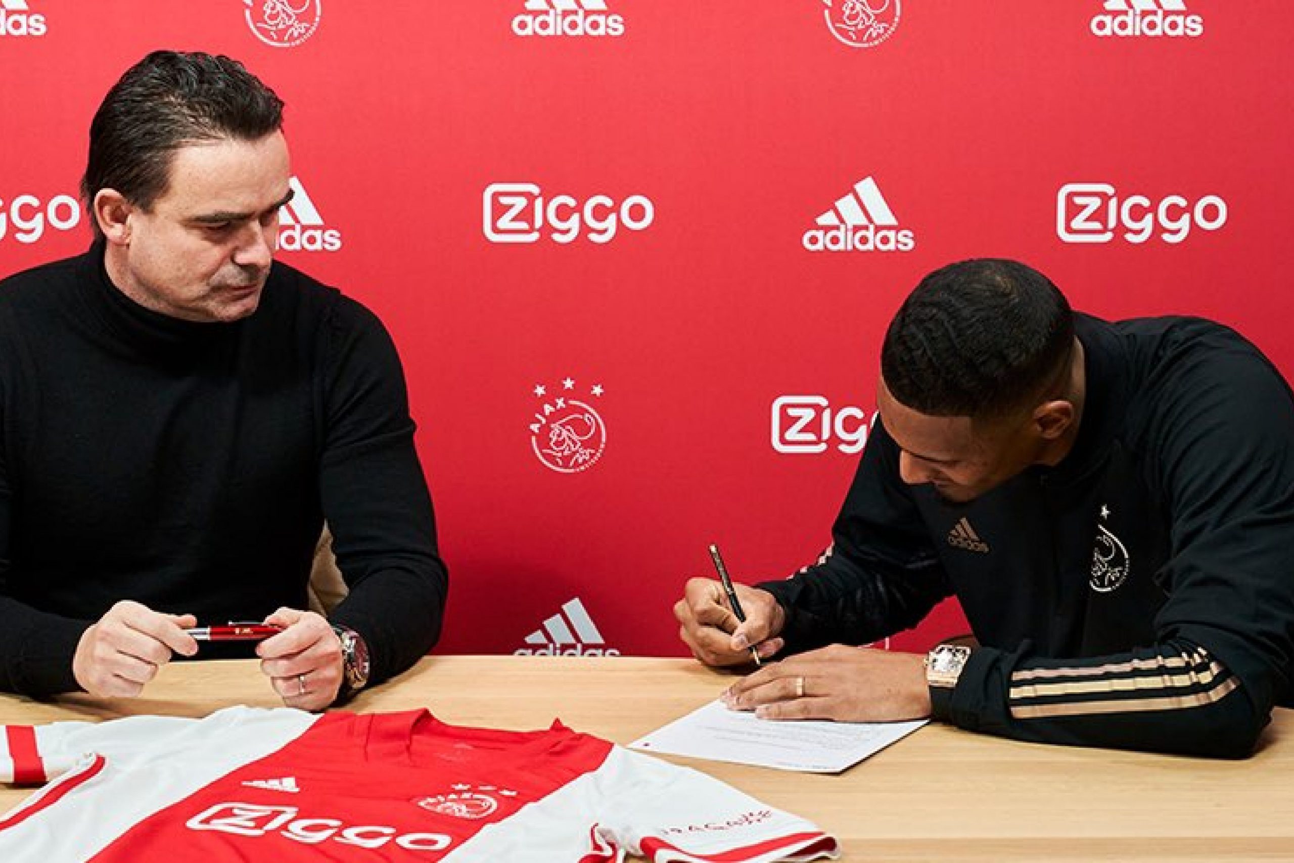 What’s Marc Overmars doing? Ajax director rips up Sebastien Haller’s contract during official unveil