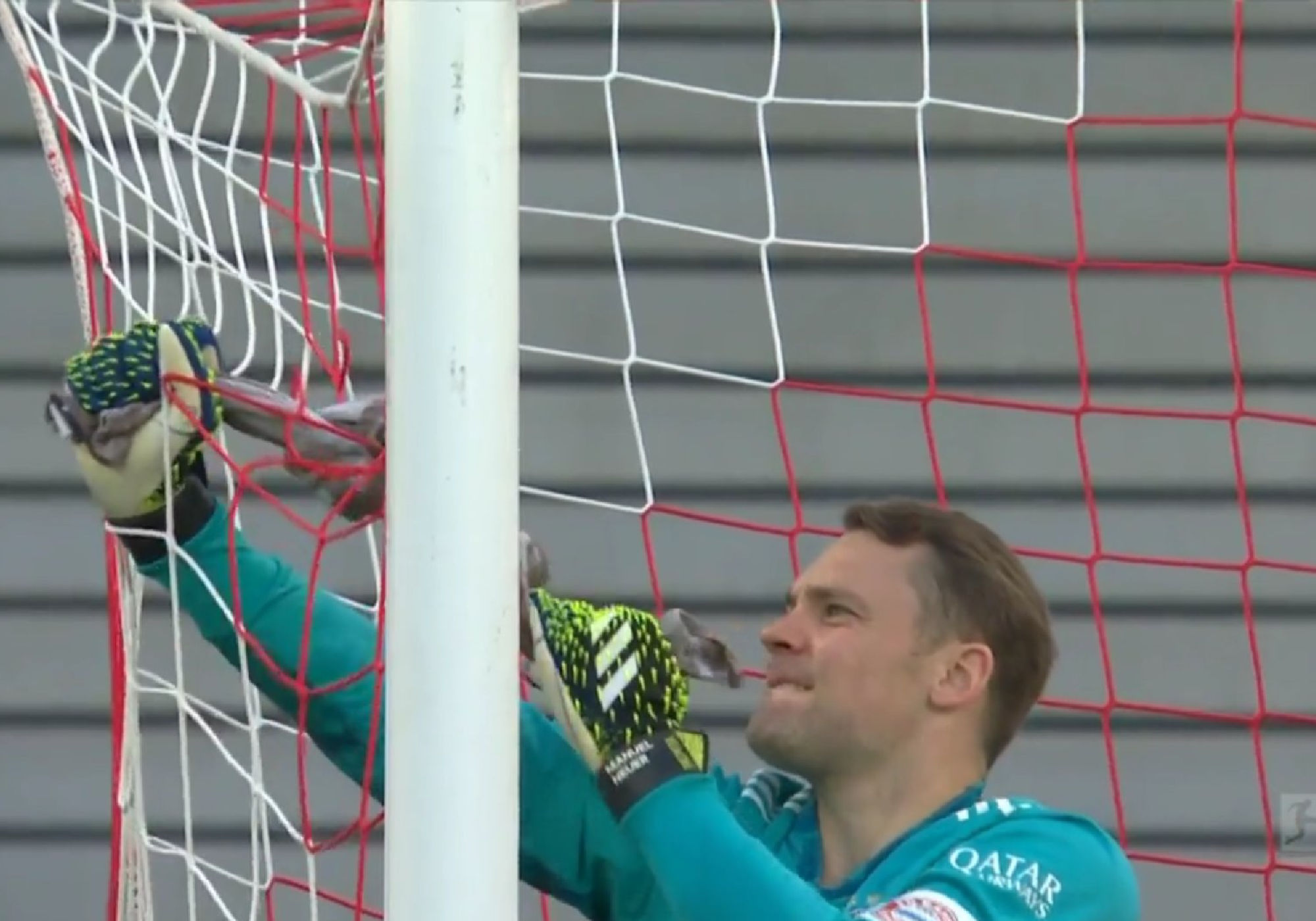 Manuel Neuer repairs a torn net with his towel but the linesman had to ruin it