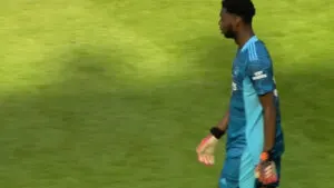 Academy goalkeeper Arthur Okonkwo walks away after commiting a horrible mistake which led to Hibernian's first goal against Arsenal