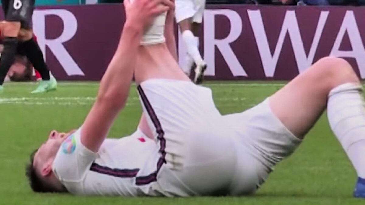 Declan Rice holds his leg up in sheer agony after getting cramped against Germany