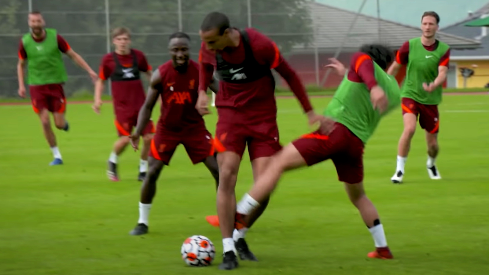 Joel Matip shoves Takumi Minamino out of his way before going on a run in training