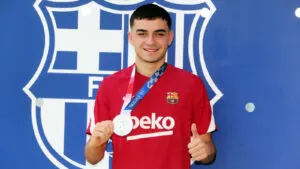Pedri shows off his silver medal as he reports back to Barcelona training