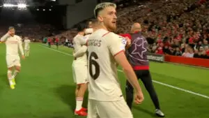 Alexis Saelemaekers points at the UCL badge against Liverpool