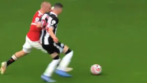 Luke Shaw in a battle with Miguel Almiron at Old Trafford