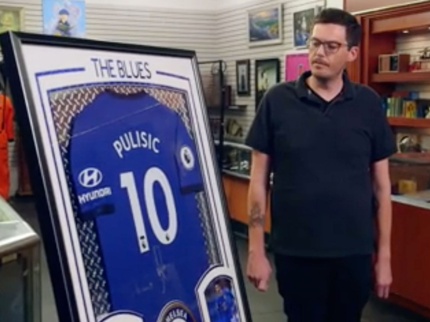 Photo of a framed Christian Pulisic shirt being sold on Pawn Stars