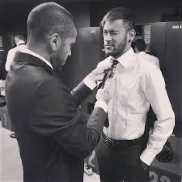 Dani Alves helping Neymar with his tie