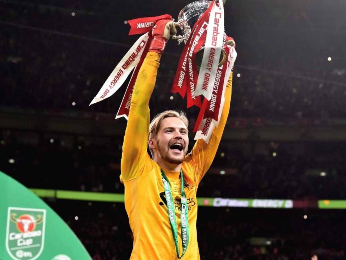 Liverpool goalkeeper Caoimhin Kelleher lifts the Carabao Cup trophy after heroics against Chelsea