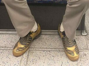 Tube commuter rocks golden Nike Total 90s