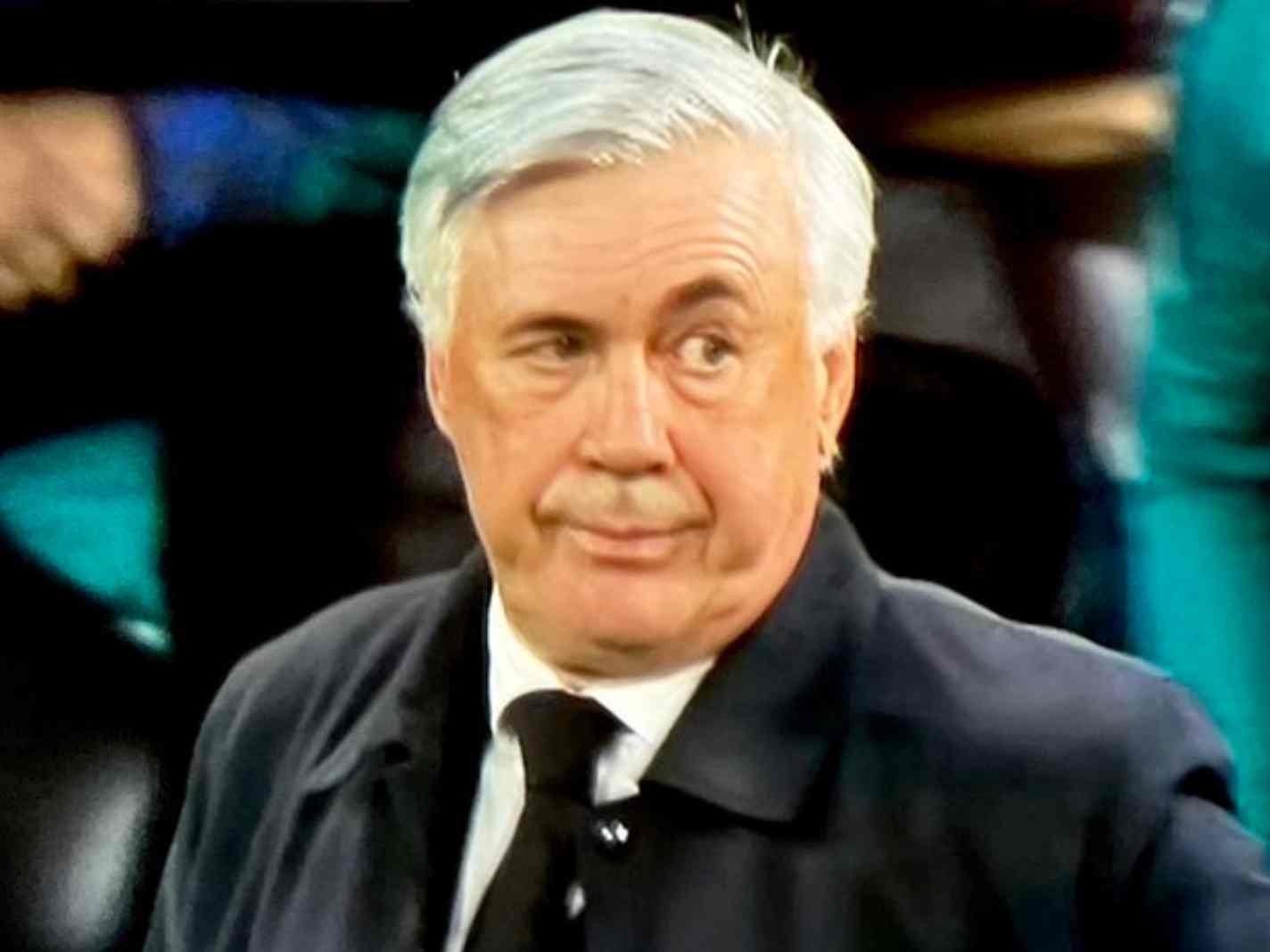 The image shows Carlo Ancelotti with his left eyebrow raised. The pose symbolizes Real Madrid's comeback wins in the Champions League.