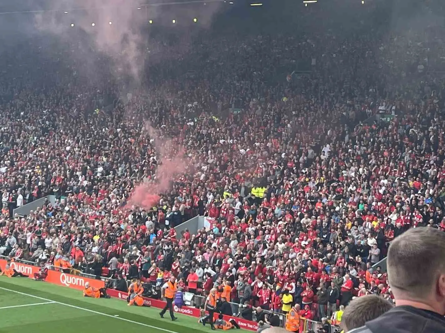 The photo shows Liverpool fans letting off a flare after thinking Aston Villa had equalized against Man City