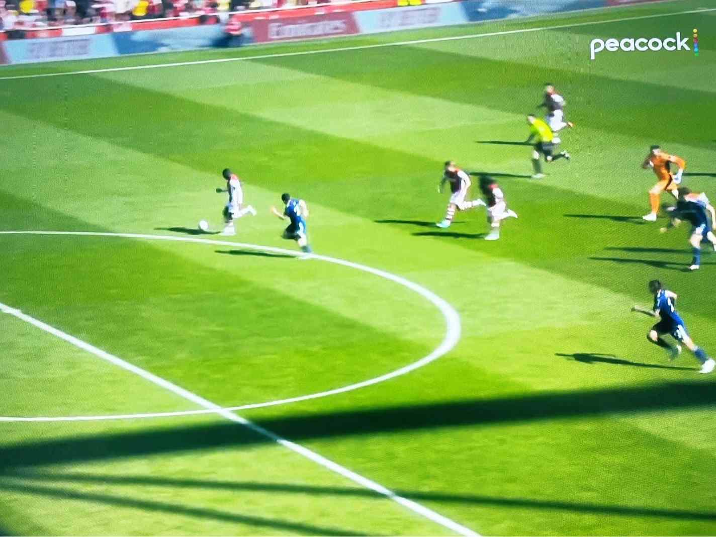 The photo shows Nicolas Pepe with the ball running towards the Leeds goal.