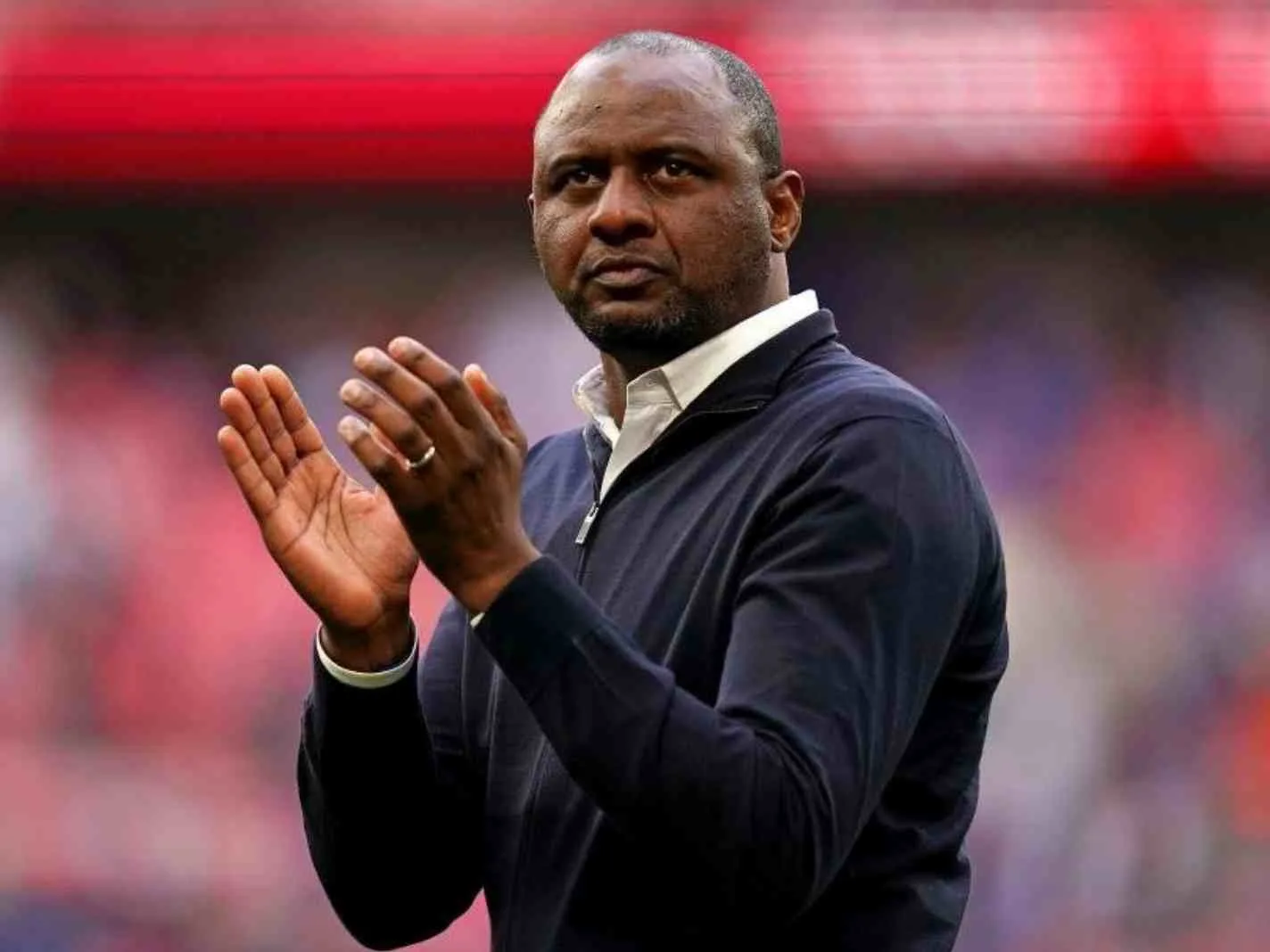 The photo shows Patrick Vieira clapping for the fans.