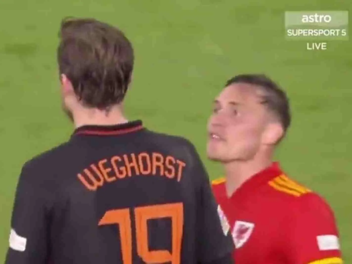 Connor Roberts (right) confronts Wout Weghorst during Netherlands v Wales.