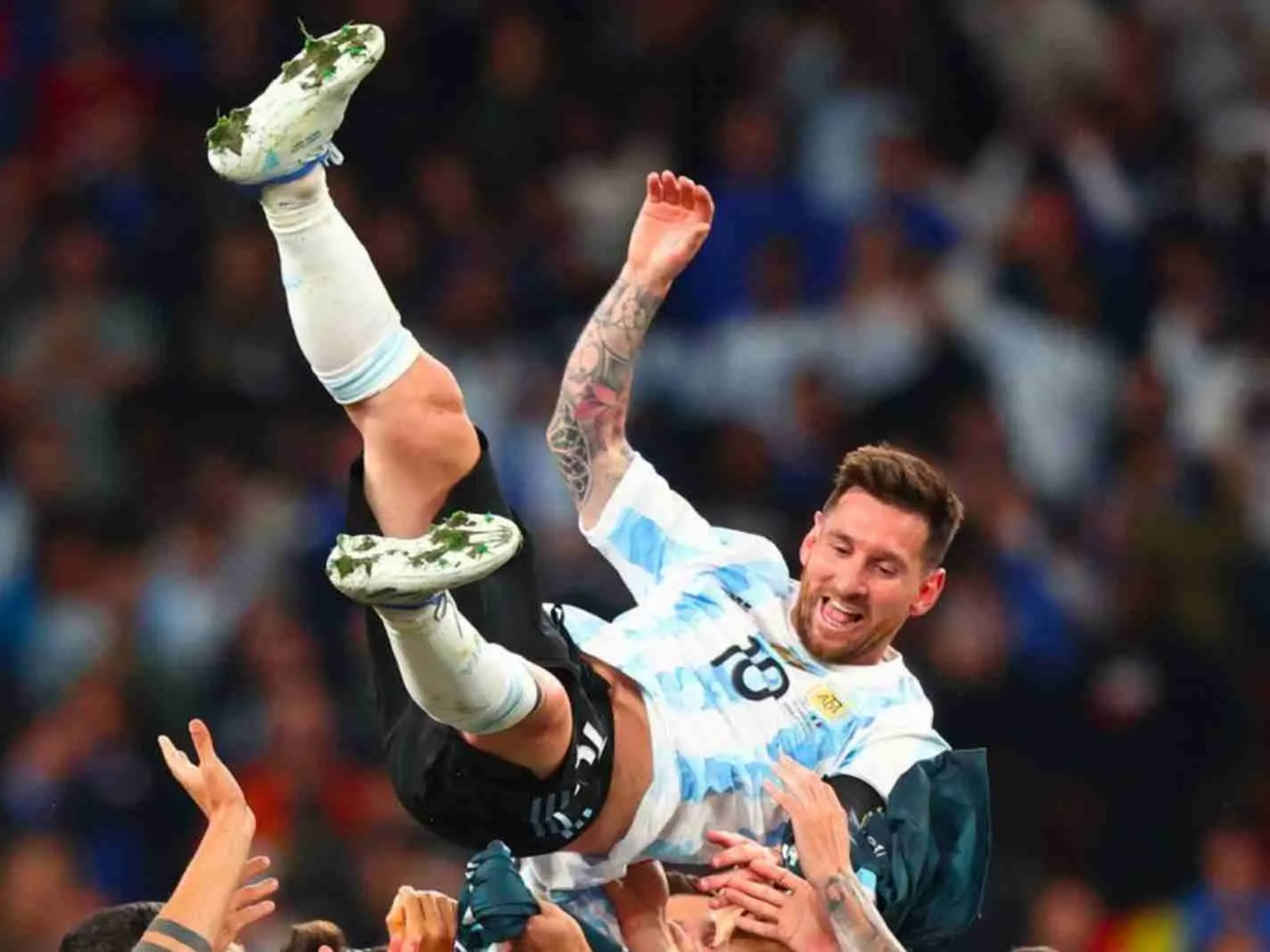 Lionel Messi hoisted up in the air by Argentina players after Finalissima victory.
