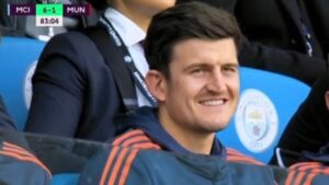 Harry Maguire smiling on bench
