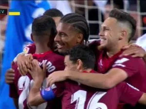 Sevilla players celebrate a goal against Valencia