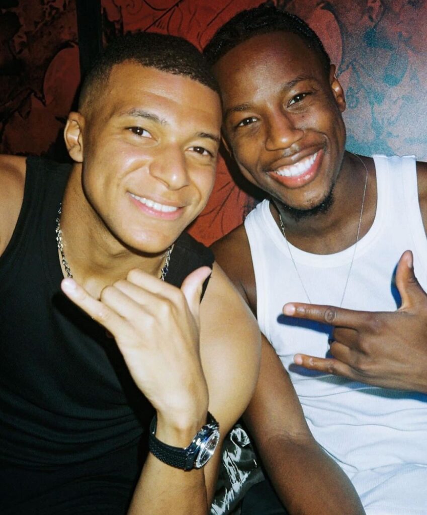 Kylian Mbappe with Brice Tchaga (right)