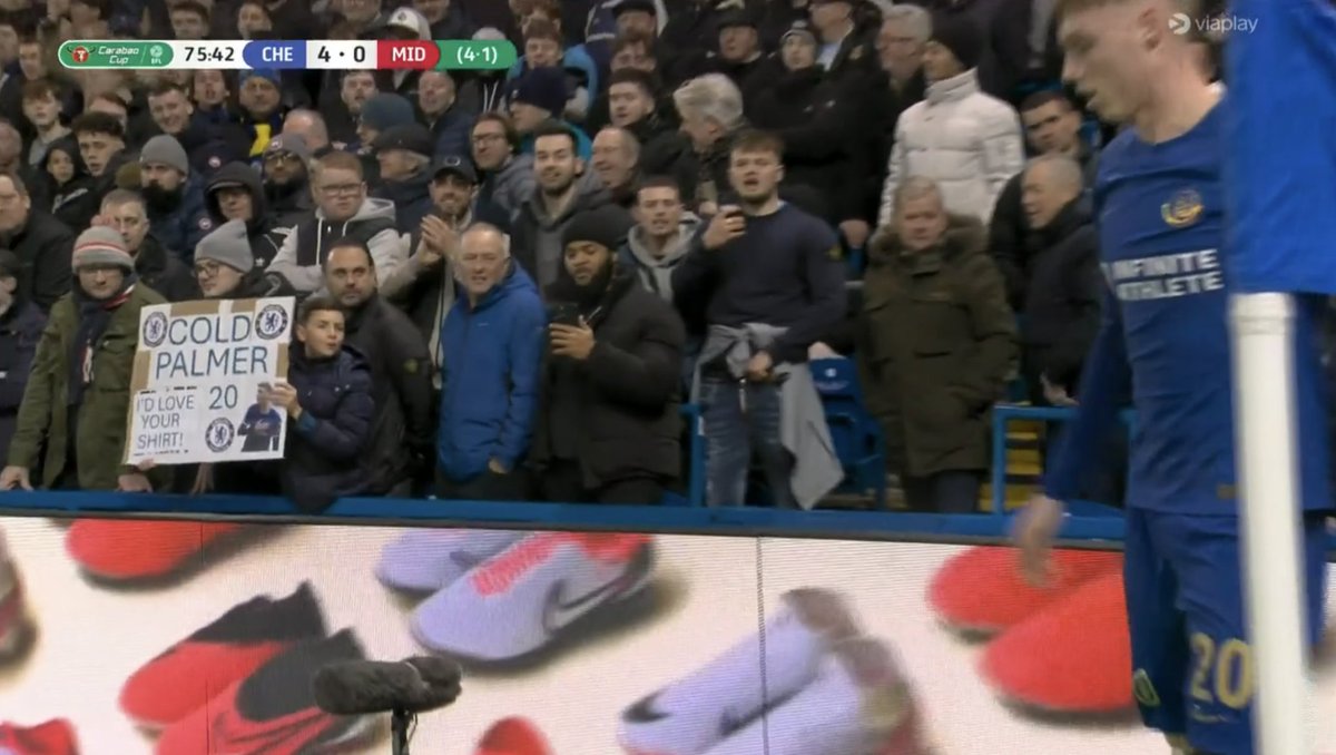 Young Chelsea fan shows off placard asking Cole Palmer for his shirt.