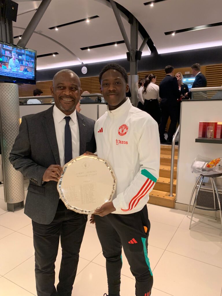 Kobbie Mainoo with his father Felix after winning the Best Youth Player at Manchester United