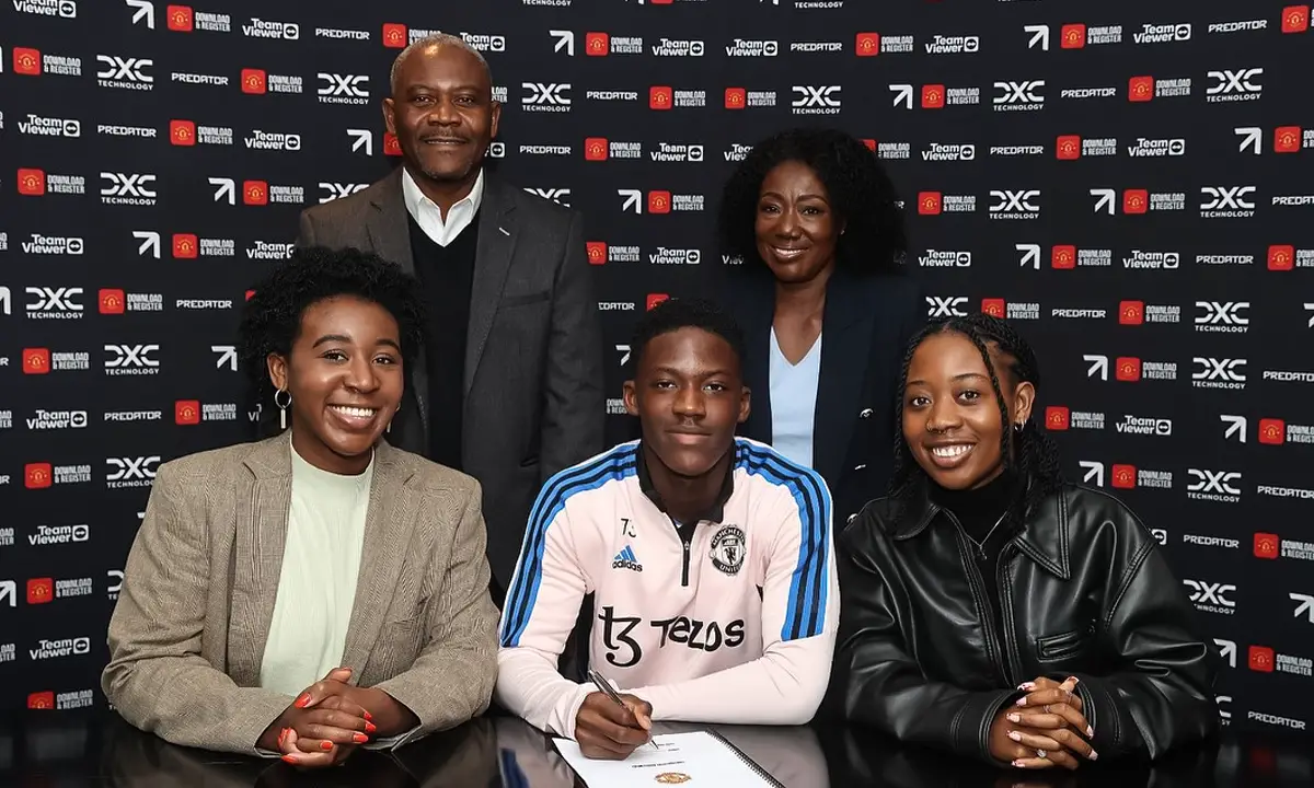 Kobbie Mainoo with his parents (standing) and sisters