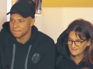 Kylian Mbappe and his mother Fayza Lamari sitting in the stands during Monaco v PSG game